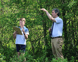 Renbrook School teacher pointing to tree with student